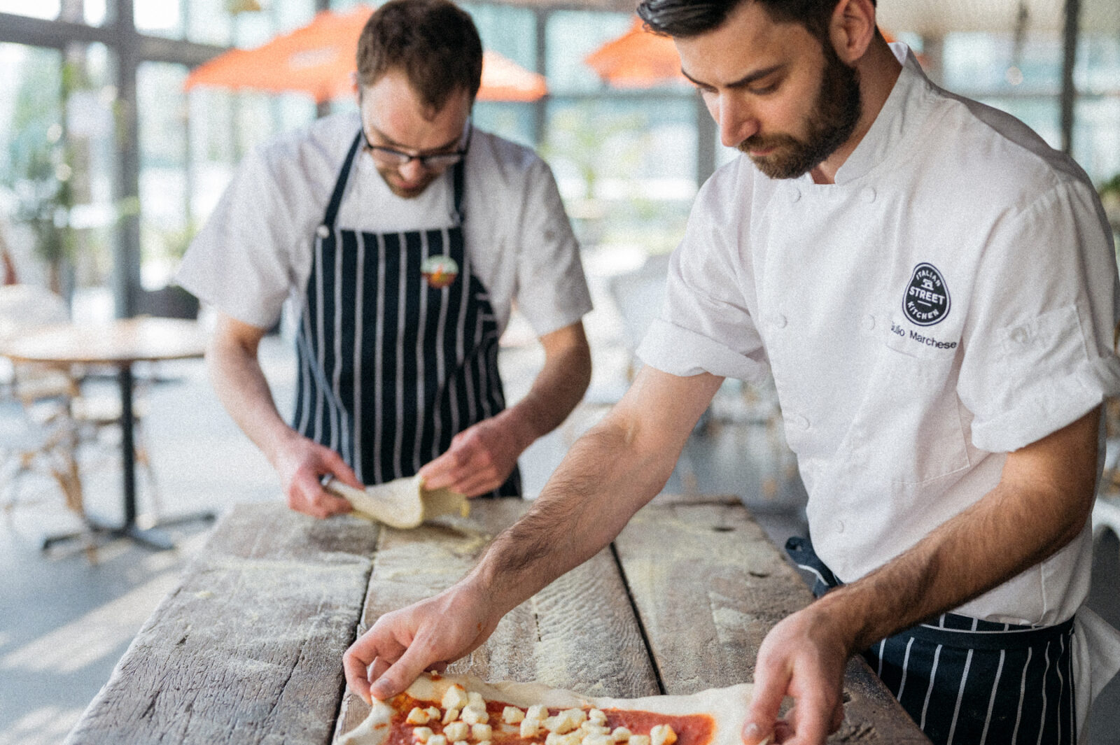 2 Expert Chefs Busy in Making Pizza